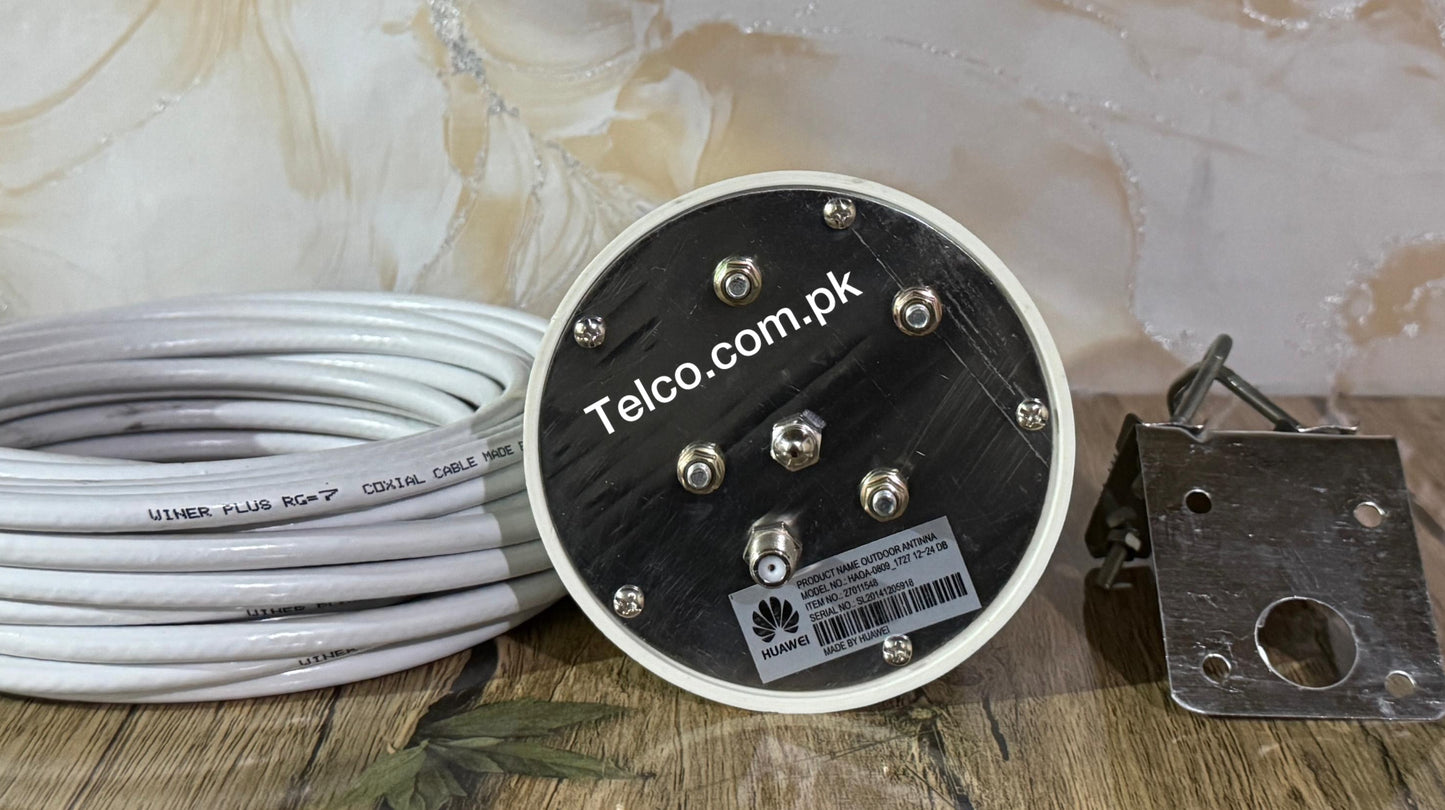 Round metallic component with 'Telco.com.pk' branding, coiled cable, and metal bracket on a textured surface.