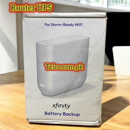 Box of Xfinity Battery Backup for Router UPS on a wooden surface with Telco.com.pk branding.